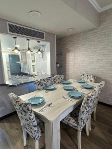 a dining room with a table and chairs at Unique duplex hotel apartment pool view in Cairo