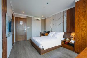 a hotel room with a bed and a television at GM Hotel and Apartment in Hai Phong +43 photos