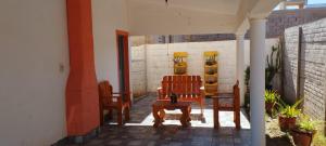 a patio with two chairs and a table at Home Talampaya in Villa Unión