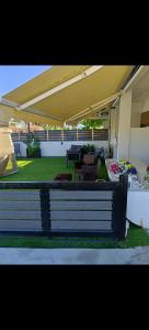 a bench sitting on the side of a patio at Garden apartment G in Xanthi