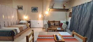 a living room with two beds and a couch at Terraza del Rio in Formosa
