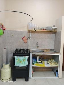 a small kitchen with a stove and a sink at Terraza del Rio in Formosa +36 photos