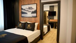 a hotel room with two beds and a mirror at Aerohub Grand Hotel in Arnavutköy