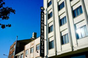 a building with a sign on the side of it at Aerohub Grand Hotel in Arnavutköy
