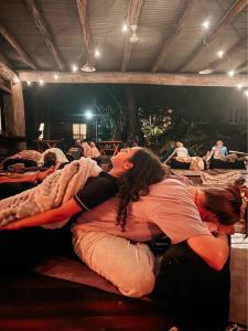 a woman laying on a bed in a room at Hidden Valley Cabins & Tours in Coolbie