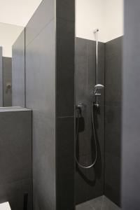 a shower in a bathroom with black tile at chillten dorsten in Dorsten +21 photos