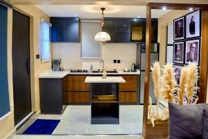 a kitchen with a island in the middle of it at Luxembourg Apartment in Lagos