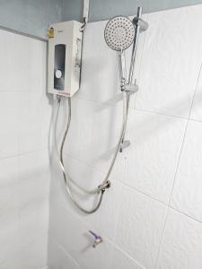 a shower with a shower head in a bathroom at Pakse Green Adventure Hostel Two in Pakse