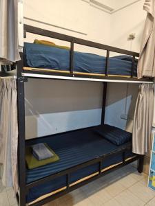 a bunk bed in a room with blue bunk beds at Pakse Green Adventure Hostel Two in Pakse +9 photos