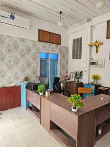 a living room with a table and a couch at Pakse Green Adventure Hostel Two in Pakse