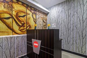 a lobby with a large painting on the wall at OYO 93463 Alwal Residency in Hyderabad
