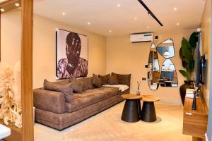 a living room with a brown couch and a table at Luxembourg Apartment in Lagos