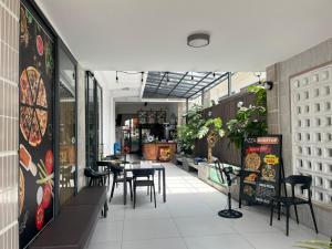 a restaurant with a table and chairs in a room at Roooftop villa can ho penhouse Tay ninh in Tây Ninh