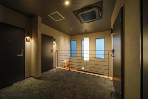 a room with a balcony with a television on the ceiling at 緑翠-Ryokusui- in Beppu