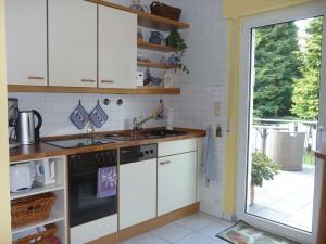 a kitchen with a sink and a stove at Trade fair and holiday accommodation in Oberursel