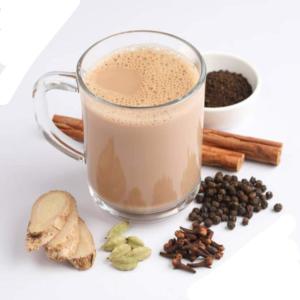 a glass mug of coffee with coffee beans and spices at Moon Garden Hotel And Restaurant in Arugam Bay