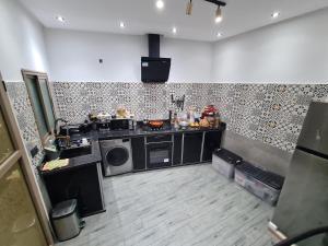a kitchen with a stove and a microwave at DAR agafay in Lalla Takerkoust