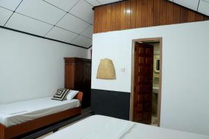 a small room with two beds and a doorway at Kyo Garden Villa in Negombo +87 photos