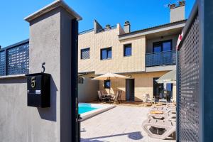 a view of a building with a patio and a swimming pool at Sun&Fun Villa in Vinarós