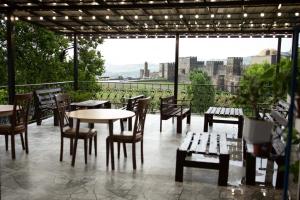 a patio with tables and chairs and a view of the city at Niss House2 in Akhaltsikhe