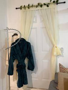 a robe hanging in front of a door at Serenity Garden Studio with Pool in Naples