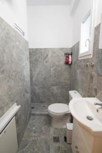 a bathroom with a toilet and a sink at Volos Blue Nest in Volos +18 photos