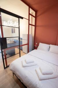 a bedroom with two beds and a mirror at Volos Blue Nest in Volos