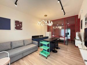 a living room with a couch and a table at Volos Blue Nest in Volos