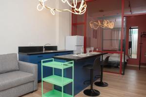 a kitchen with a blue island with a counter top at Volos Blue Nest in Volos