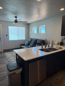 a kitchen and living room with a sink and a couch at Desert view apartment in Page