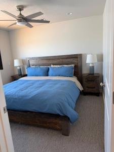 a bedroom with a large bed with blue pillows at Desert view apartment in Page