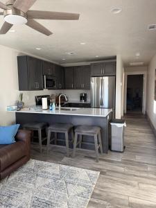 a kitchen with a large island in a living room at Desert view apartment in Page