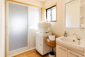 a bathroom with a sink and a mirror at Good Stay Apartment Nichinan - Sea View & Free Parking in Nichinan +25 photos