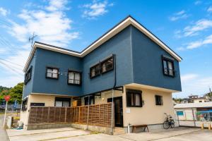 a blue house on the side of a street at Good Stay Apartment Nichinan - Sea View & Free Parking in Nichinan