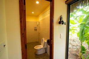 a bathroom with a toilet in a room at Mango Home in Ben Tre