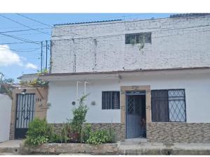 a white brick house with a door and windows at departamento bugambilias in Tepic
