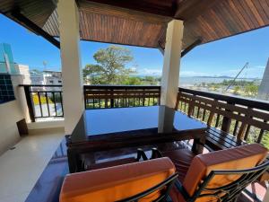 a balcony with a table and two chairs at Jomtien Beach Penthouses in Jomtien Beach