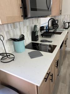 a kitchen with a sink and a stove top oven at Roam America Horseshoe Bend in Page