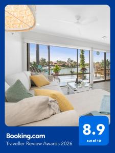 a living room with two couches and a view of the ocean at Absolute Waterfront Marina Views in Patterson Lakes