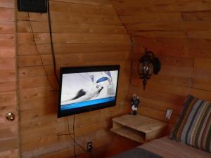 a television on a wall in a room at L'Oasis du Pirate in Quebec City