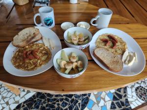 a table with plates of food on a table at Homestay Natural Paradise habitación 2 in San Cristóbal +8 photos