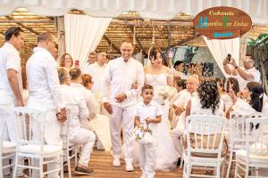 a bride and groom walking down the aisle at their wedding at Mar Villa Eco Lodge Surf & Kite Perla Marina by Encuentro Beach in Sosúa +40 photos