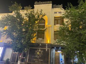 a building with a sign on the front of it at Suleyman hotel in Bukhara