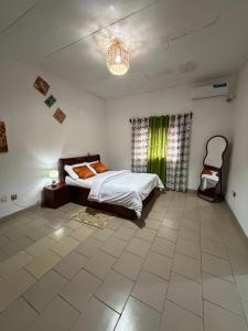 a bedroom with a bed and a green curtain at My stay in Yaoundé