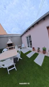 a patio with a table and a picnic table at Les Rives du vignoble in Ingersheim