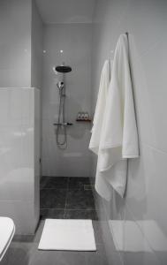 a bathroom with white towels hanging on a wall at Inpeng View Hotel in Vientiane +46 photos