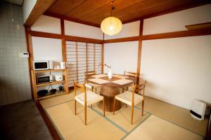 a dining room with a table and chairs at Nomachi Villa in Kanazawa