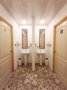 a bathroom with two sinks and two toilets at Camping Green house in Palma