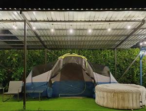 a tent under awning in a field of grass at Camping Green house in Palma