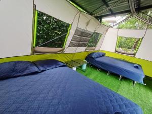 a bedroom with a bed in a tent at Camping Green house in Palma